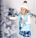 Cute little girl decorating Christmas tree