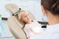 A cute little girl at the dentist`s office and a doctor in the f