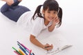 Cute little girl doing homework, reading a book, coloring pages, writing and painting. Children paint. Kids draw. Preschooler with Royalty Free Stock Photo