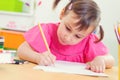 Cute little girl drawing with colorful pencils Royalty Free Stock Photo