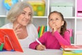 Cute little girl drawing with her grandmother Royalty Free Stock Photo