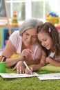 Cute little girl drawing with her grandmother Royalty Free Stock Photo
