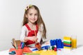 Cute little girl drawing with paint and paintbrush at home Royalty Free Stock Photo