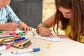 Cute little girl drawing and painting at kindergarten. Creative activities kids club Royalty Free Stock Photo