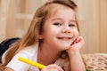 Cute little girl drawing with pencils.