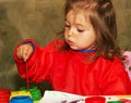 Cute little girl drawing and studying at daycare