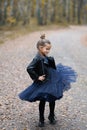 Cute little girl dreaming of becoming a ballerina. Child girl in a blue dress dancing on the park. Royalty Free Stock Photo