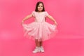 Cute little girl dreams of becoming a ballerina. Little Dancing Girl. Studio Shoot Over Pink Background Royalty Free Stock Photo