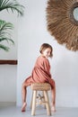 Cute little girl in a dress posing for a photo in a tropical style room Royalty Free Stock Photo