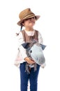 Cute little girl dressed like a cowboy playing with a homemade h Royalty Free Stock Photo