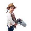 Cute little girl dressed like a cowboy playing with a homemade h Royalty Free Stock Photo