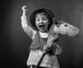 Cute little girl dressed like a cowboy playing with a homemade h Royalty Free Stock Photo