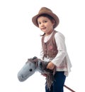 Cute little girl dressed like a cowboy playing with a homemade horse Royalty Free Stock Photo