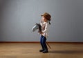 Cute little girl dressed like a cowboy playing with a homemade horse Royalty Free Stock Photo