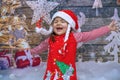 Cute Little Girl dressed in red dress bringing the Christmas spirit.