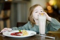 Cute little girl drinking milk coctail