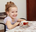 Cute little girl drinking tea at the old table. Royalty Free Stock Photo