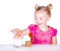 Cute little girl dunking cookie in milk