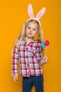 Cute little girl with Easter bunny ears holding colorful eggs Royalty Free Stock Photo