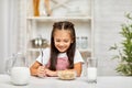 Cute little girl eating breakfast: cereal with the milk Royalty Free Stock Photo