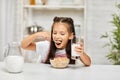 Cute little girl eating breakfast: cereal with the milk Royalty Free Stock Photo