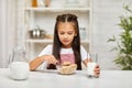 Cute little girl eating breakfast: cereal with the milk Royalty Free Stock Photo