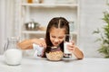 Cute little girl eating breakfast: cereal with the milk Royalty Free Stock Photo