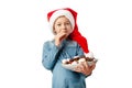 Cute little girl eating candy for christmas and new year. Portrait of a child in a Santa hat, isolated on a white background Royalty Free Stock Photo