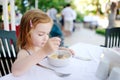 Cute little girl eating cereal Royalty Free Stock Photo