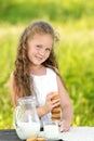 Cute little girl eating chocolate chip cookie on green background Royalty Free Stock Photo