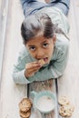 Cute little girl eating cookies with milk Royalty Free Stock Photo