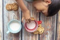 Cute little girl eating cookies with milk Royalty Free Stock Photo