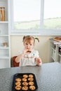 Cute little girl eating cookies secretly Royalty Free Stock Photo