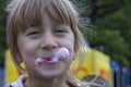 Cute little girl eating cotton candy. A walk in the summer park. Summer vacation. Outdoor Activities. Royalty Free Stock Photo