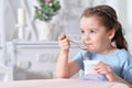 Portrait of cute little girl eating delicious yogurt Royalty Free Stock Photo