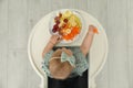 Cute little girl eating healthy food, top view Royalty Free Stock Photo