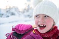 Cute little girl while eating icicle on beautiful winter day Royalty Free Stock Photo