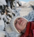 cute little girl while eating icicle on beautiful winter day Royalty Free Stock Photo