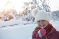 cute little girl while eating icicle on beautiful winter day Royalty Free Stock Photo