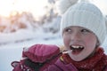 cute little girl while eating icicle on beautiful winter day Royalty Free Stock Photo