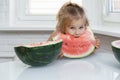 little girl eating watermelon in the kitchen Royalty Free Stock Photo