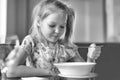 Cute little girl eating a soup in the restaurant Royalty Free Stock Photo