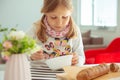 Cute little girl eating soup with whole grain bread at home Royalty Free Stock Photo