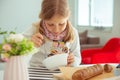 Cute little girl eating soup with whole grain bread at home Royalty Free Stock Photo