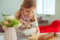 Cute little girl eating soup with whole grain bread at home Royalty Free Stock Photo