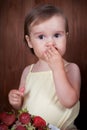 Cute little girl eating strawberries Royalty Free Stock Photo