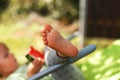 Cute little girl eating watermelon on a deck chair in the garden in summertime Royalty Free Stock Photo
