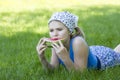 Cute little girl eating watermelon on the grass Royalty Free Stock Photo