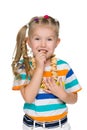 Cute little girl eats bagels Royalty Free Stock Photo