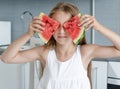 Cute little girl eats a watermelon in the kitchen Royalty Free Stock Photo